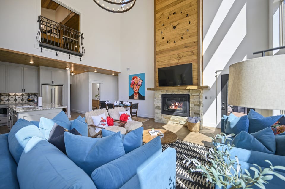 Luxury Broken Bow cabin living room with soaring ceilings and a cozy fireplace.