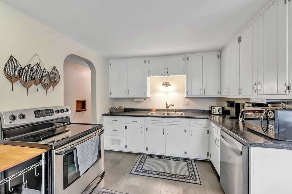 Fully equipped kitchen with pots/pans, utensils, place setting for 6 to 8 people, and modern appliances