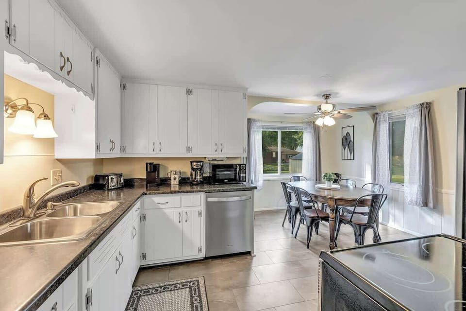 Fully equipped kitchen with pots/pans, utensils, place setting for 6 to 8 people, and modern appliances
