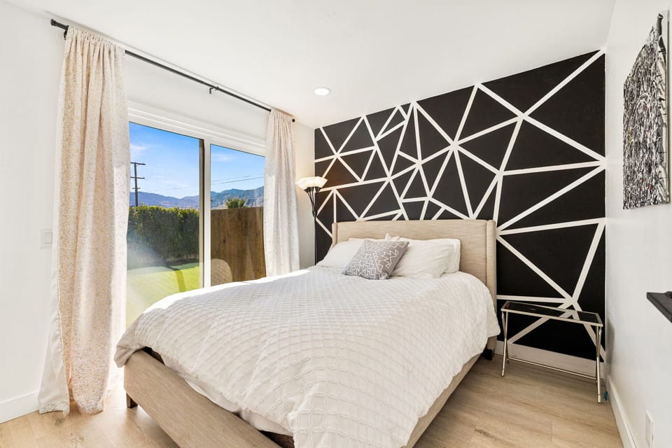 Black and white themed bedroom with queen bed