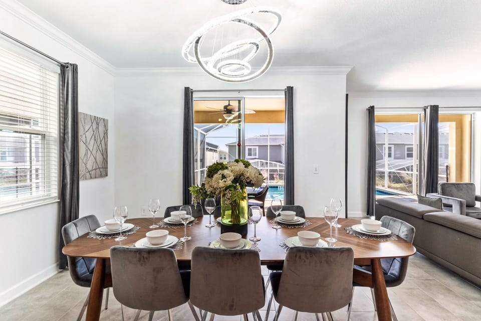 Fanciful Dining Area of the Home in Davenport Florida - Indulge in the art of dining on a grand scale at its dining area  - Meal becomes an event, and every gathering is a celebration of taste - Statement chandelier