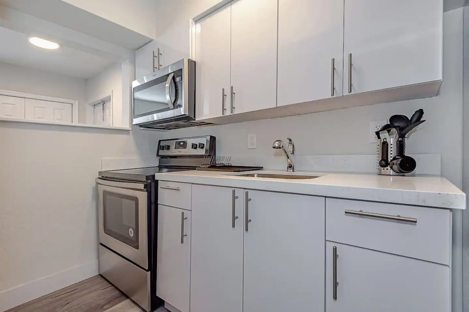 Featuring white quartz countertop and kitchen cabinet design