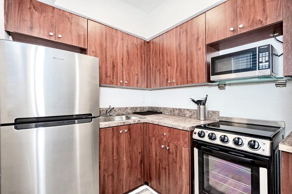 Kitchen with stainless steel appliances. 2m video tour includes open cabinets to show supplies.