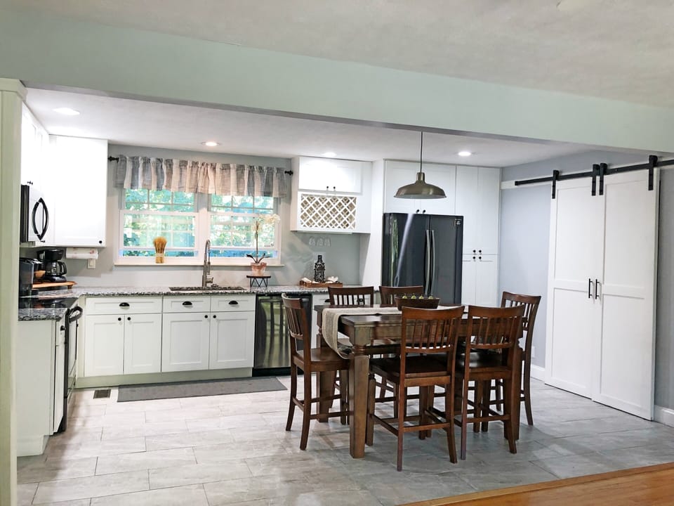 Spacious kitchen stocked with cookware. 