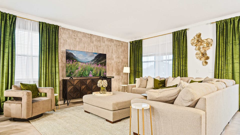 Elegant living room with plush seating, bold green drapes, and modern charm