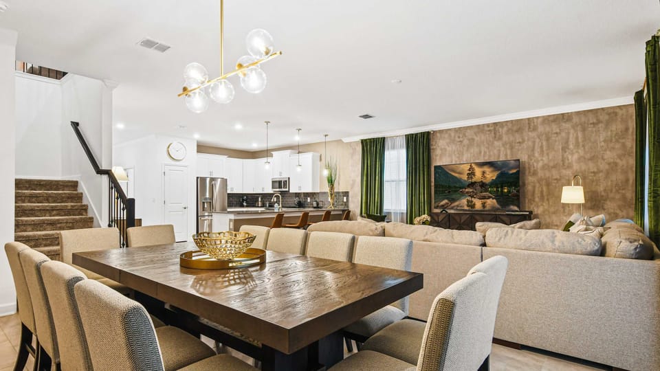 Open-concept living with modern kitchen, spacious dining, and cozy lounge area