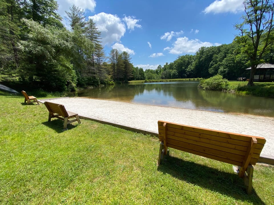 Private sandy beach area at Fleetwood Falls Community, perfect for relaxing by the peaceful community lake