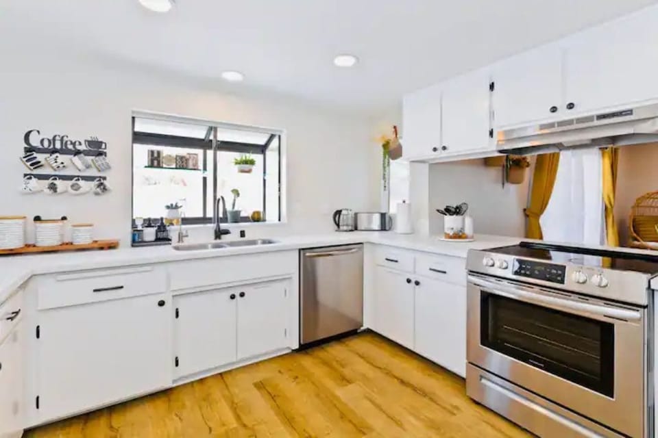 Large kitchen equipped with many essential cooking tools.