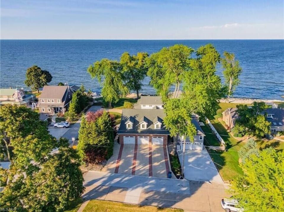Aerial view of parking area and house. Looking north towards the lake.