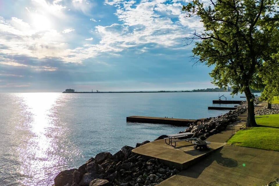 Calm morning water with our picnic table and fire pit. 
