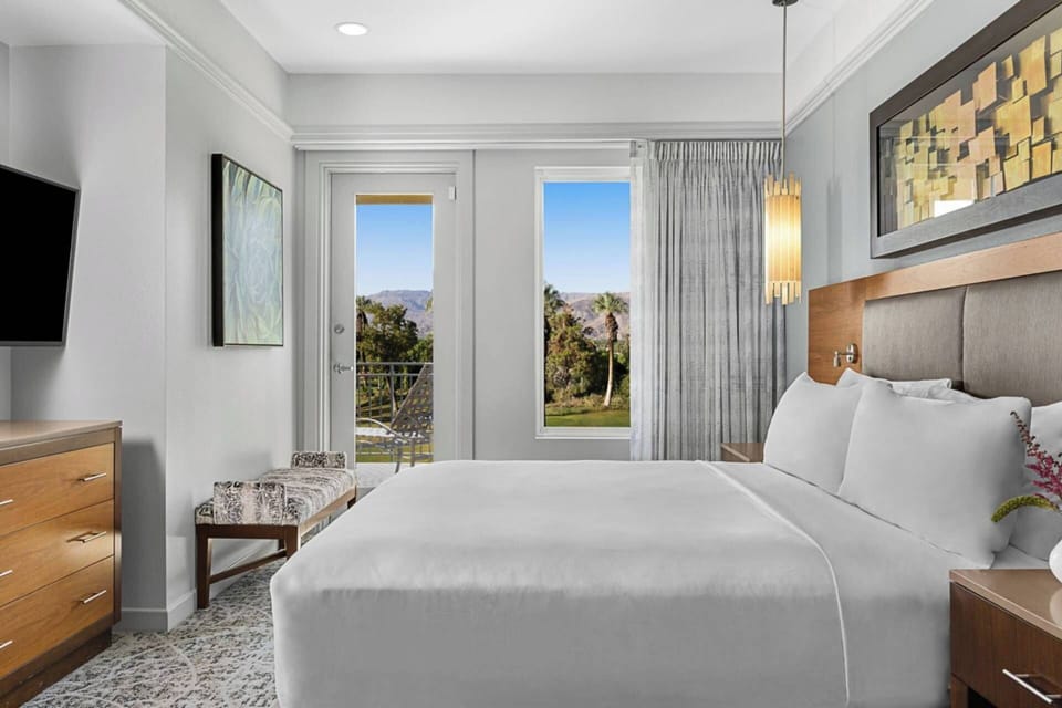 Primary Bedroom features a king bed and door to a private balcony.