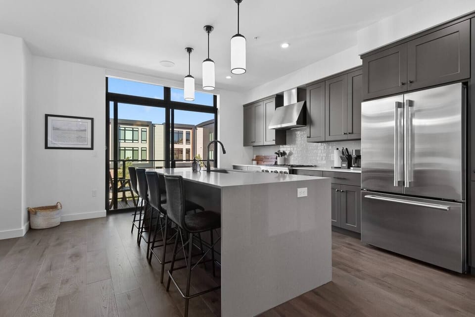 The second floor features an open concept kitchen with gourmet appliances, patio with teak dining set, walk-in pantry and formal dining area as well as an adjacent living room area with a gas fire place and wet bar.