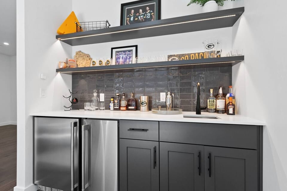 The second floor features an open concept kitchen with gourmet appliances, patio with teak dining set, walk-in pantry and formal dining area as well as an adjacent living room area with a gas fire place and wet bar.