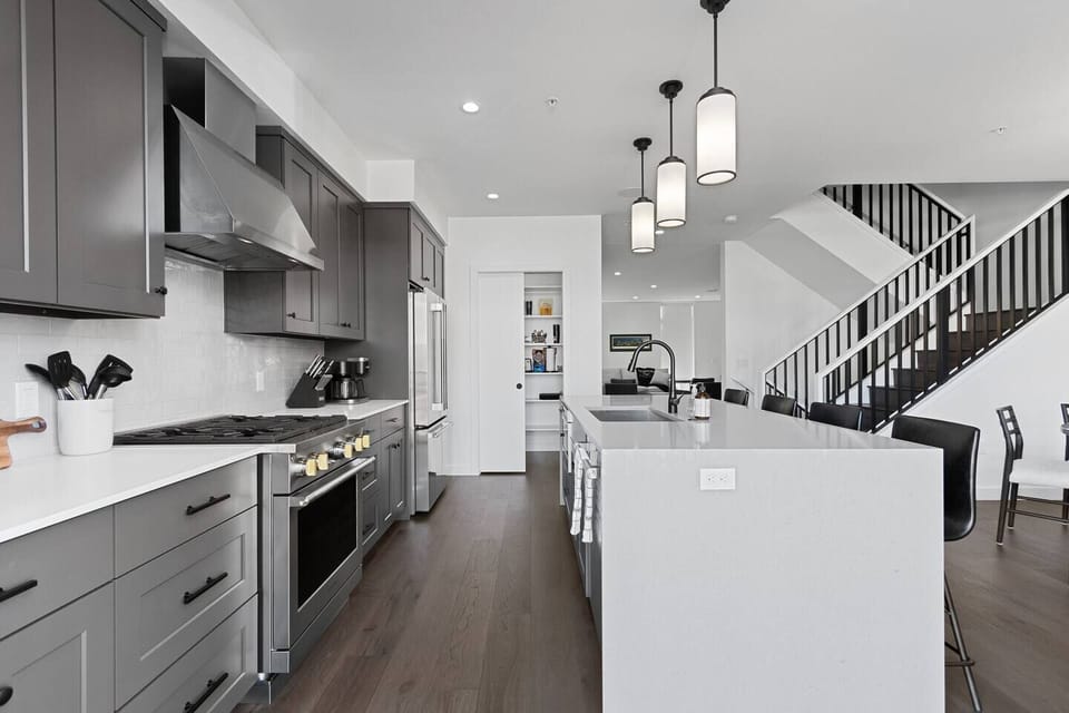 The second floor features an open concept kitchen with gourmet appliances, patio with teak dining set, walk-in pantry and formal dining area as well as an adjacent living room area with a gas fire place and wet bar.