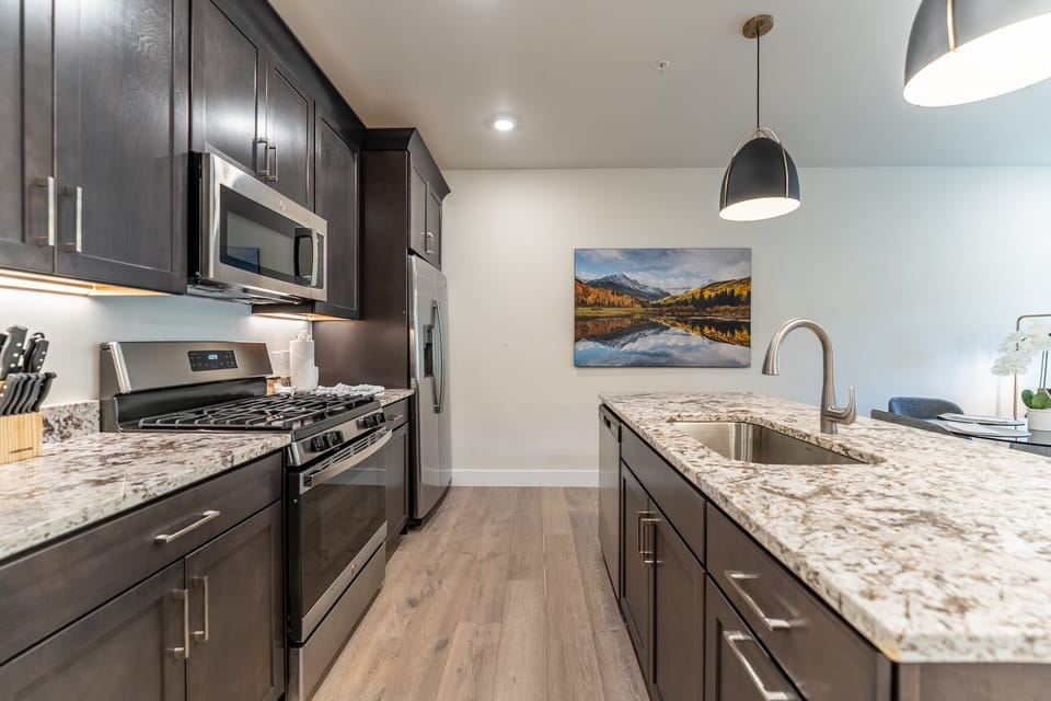 Your gourmet kitchen features sleek granite counters, stainless steel appliances, and pendant lighting for memorable meal prep.