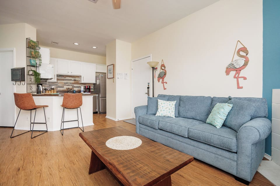 Relax in this stylish open-concept living space with plush seating and a fully equipped kitchen for your comfort.
