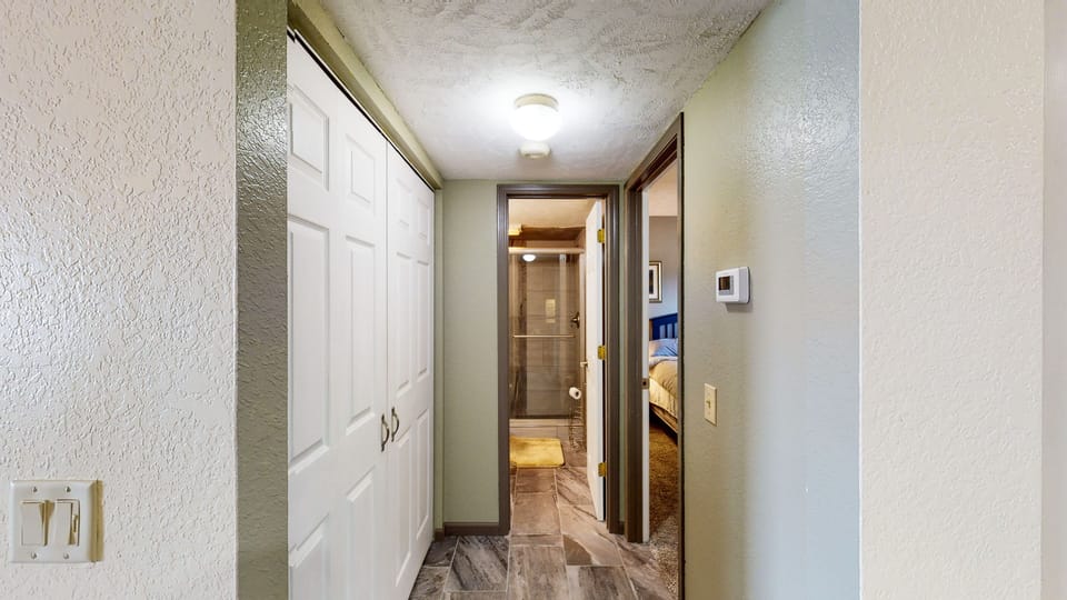 Laundry closet and hall to bedroom 1