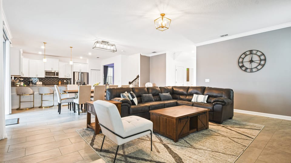 Spacious living room area with cozy sofa, perfect for family reunion.
