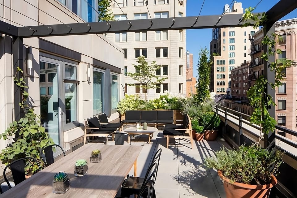 Dine outdoors under the pergola in a lush terrace oasis.