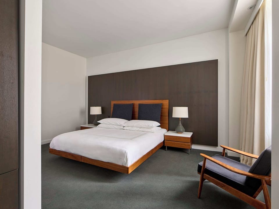 Unwind in a serene bedroom with clean modern lines.