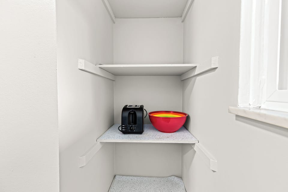 The pantry is also well-lit and has plenty of storage space, making it the perfect place to keep your groceries and kitchen supplies.