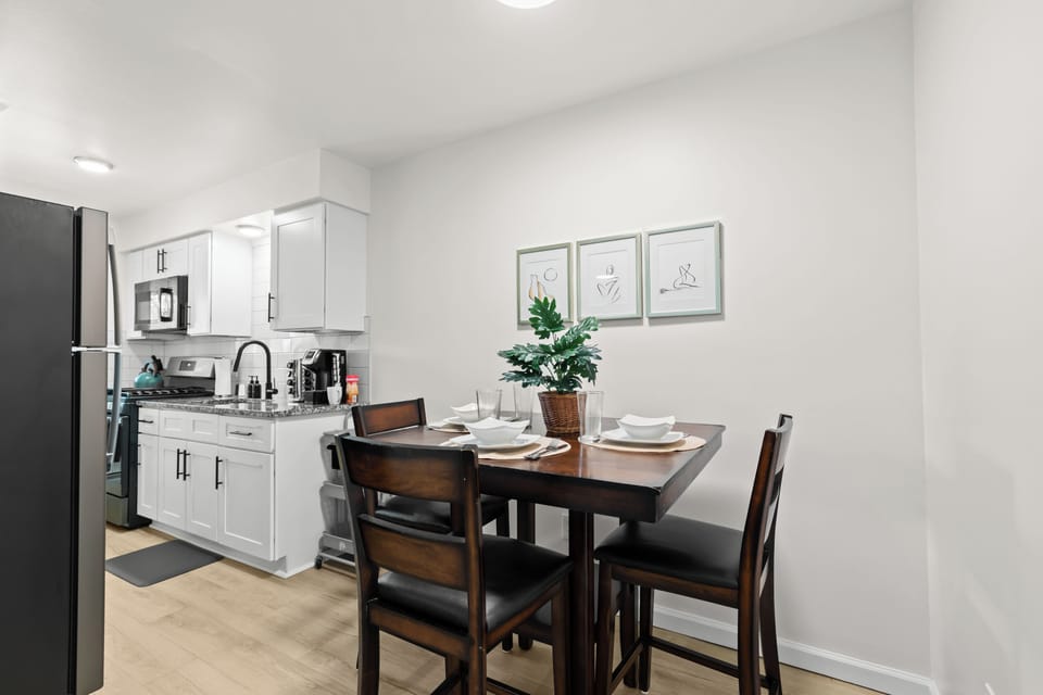 Cozy up in this charming kitchen with a table and chairs.