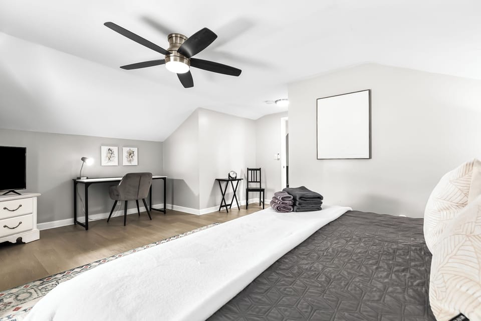 The master bedroom is equipped with a 43-inch Smart TV for your entertainment needs and a functional office desk for your work or study requirements.