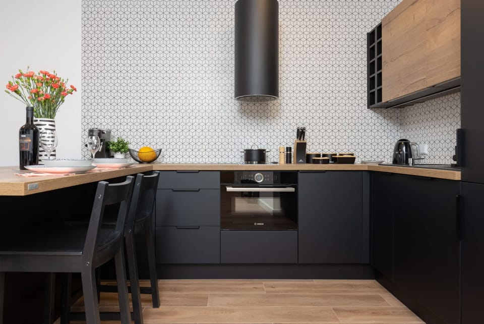 Fully equipped kitchenette with induction cooktop and dining area.