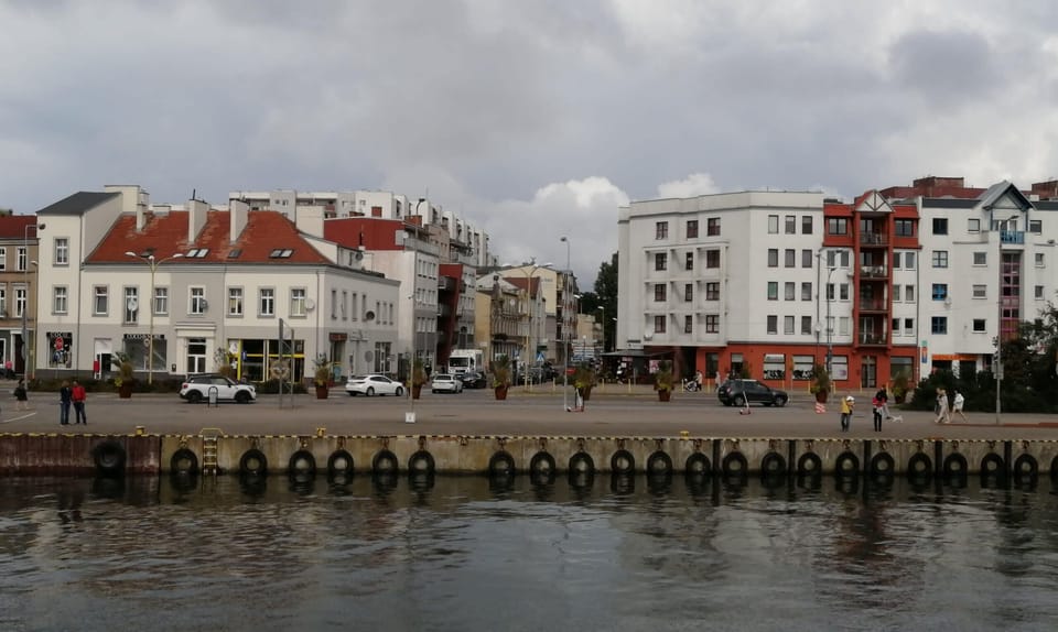 Scenic waterfront view showcasing charming architecture and serene surroundings.
