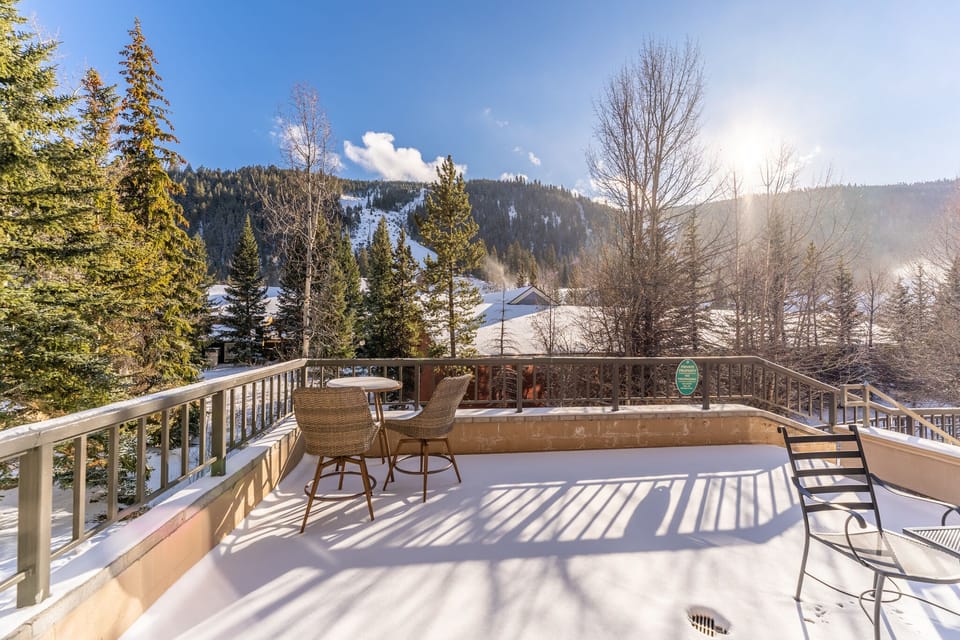 Unwind on your private balcony with stunning mountain views and soak in the hot tub surrounded by winter wonderland.
