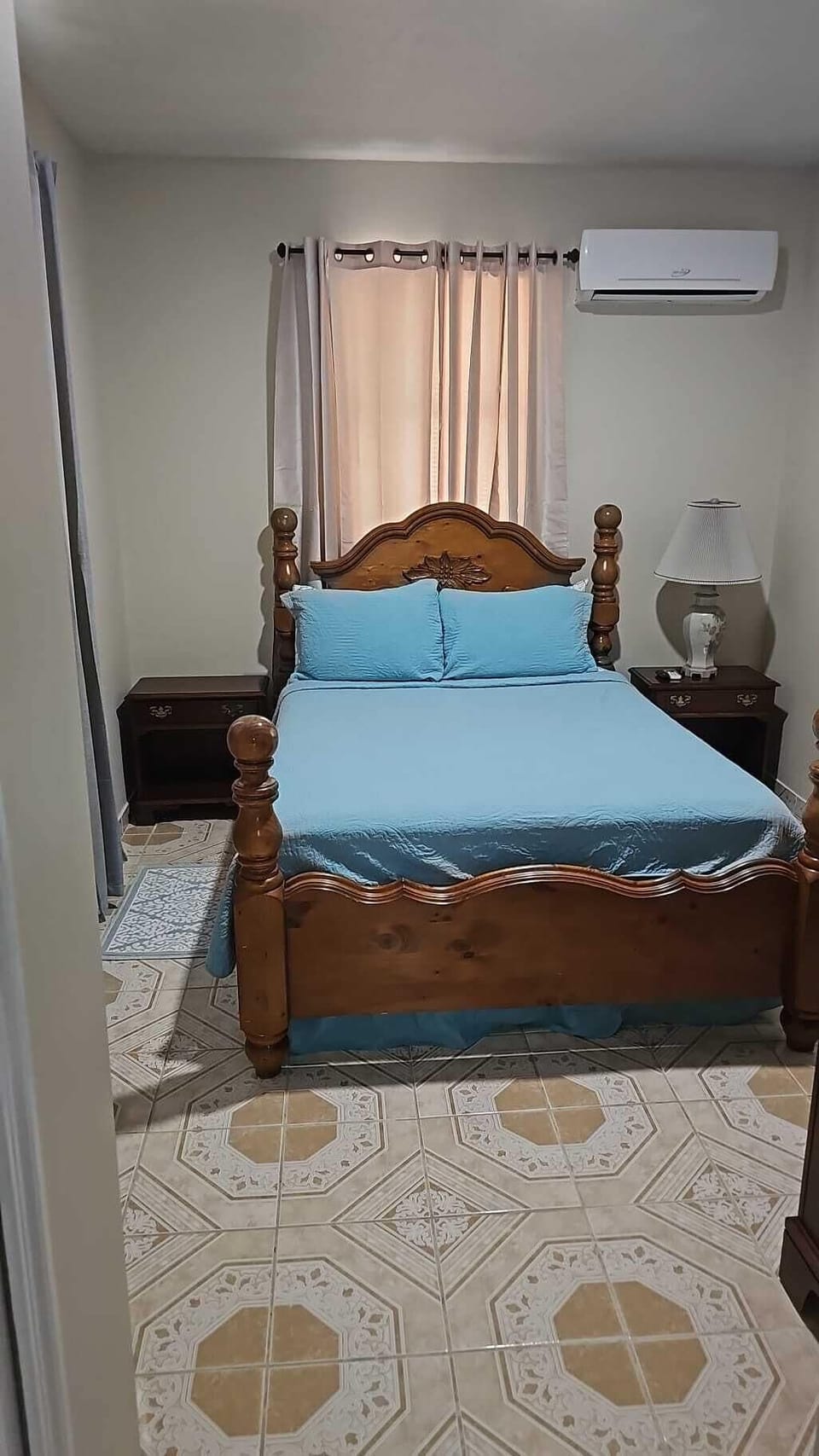 Master bedroom with Roku TV and mini split AC unit.