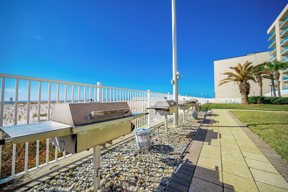 Grill up delicious meals with beachfront views and palm trees in this inviting outdoor space perfect for gatherings