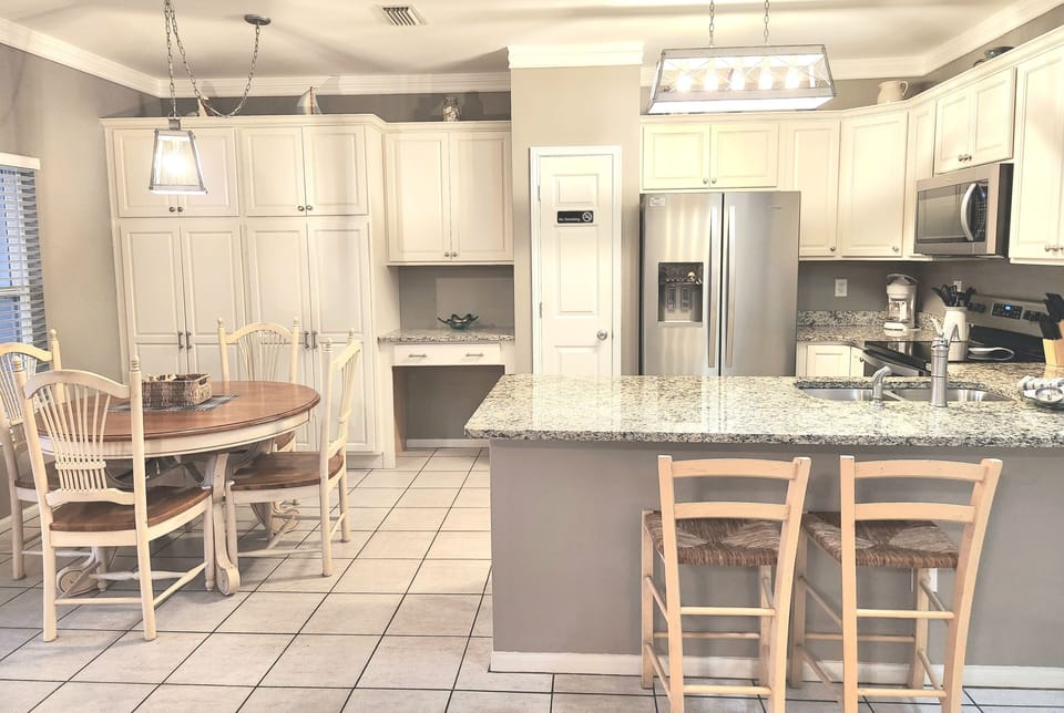 Dining table with expandable leaf.  Plan or do remote work at desk tucked in!