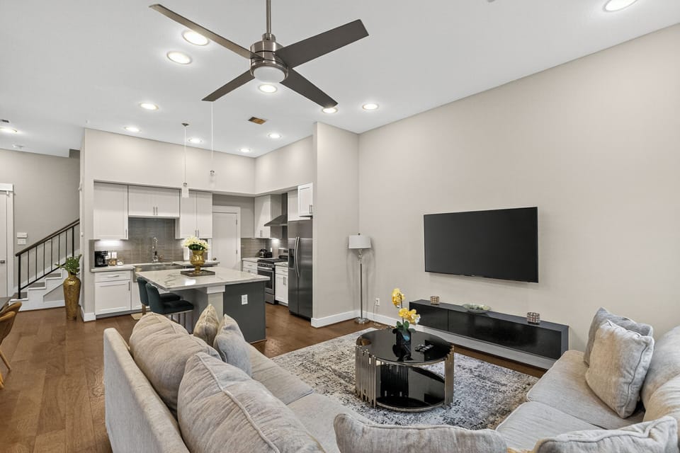Living room with 65" TV and Lux gold round center pieces