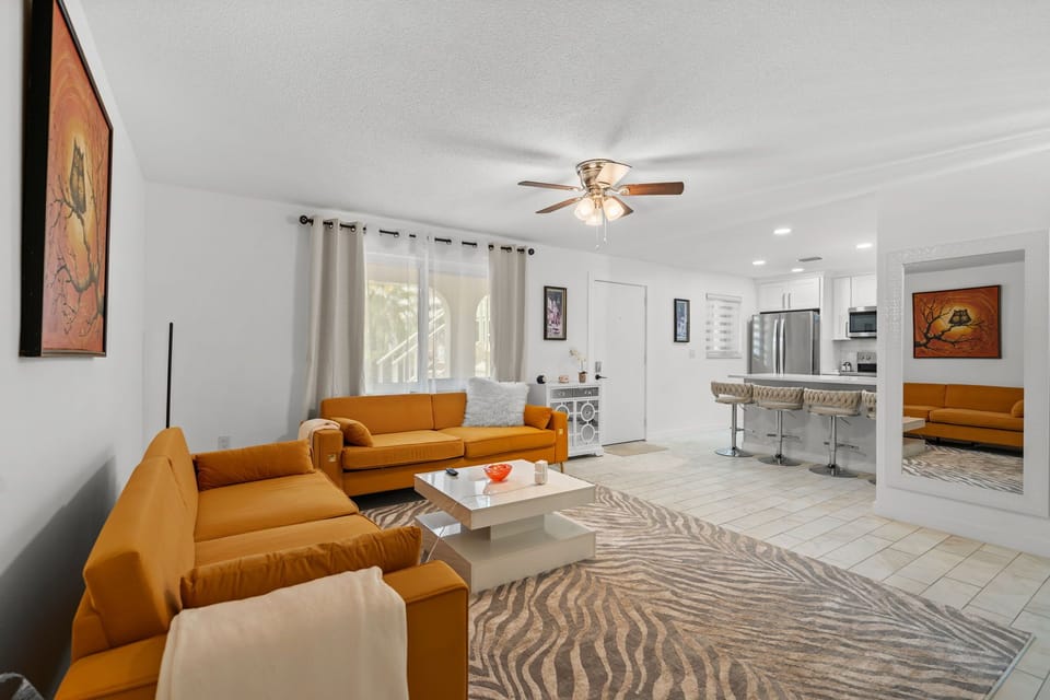 Living room area with partial view of the kitchen