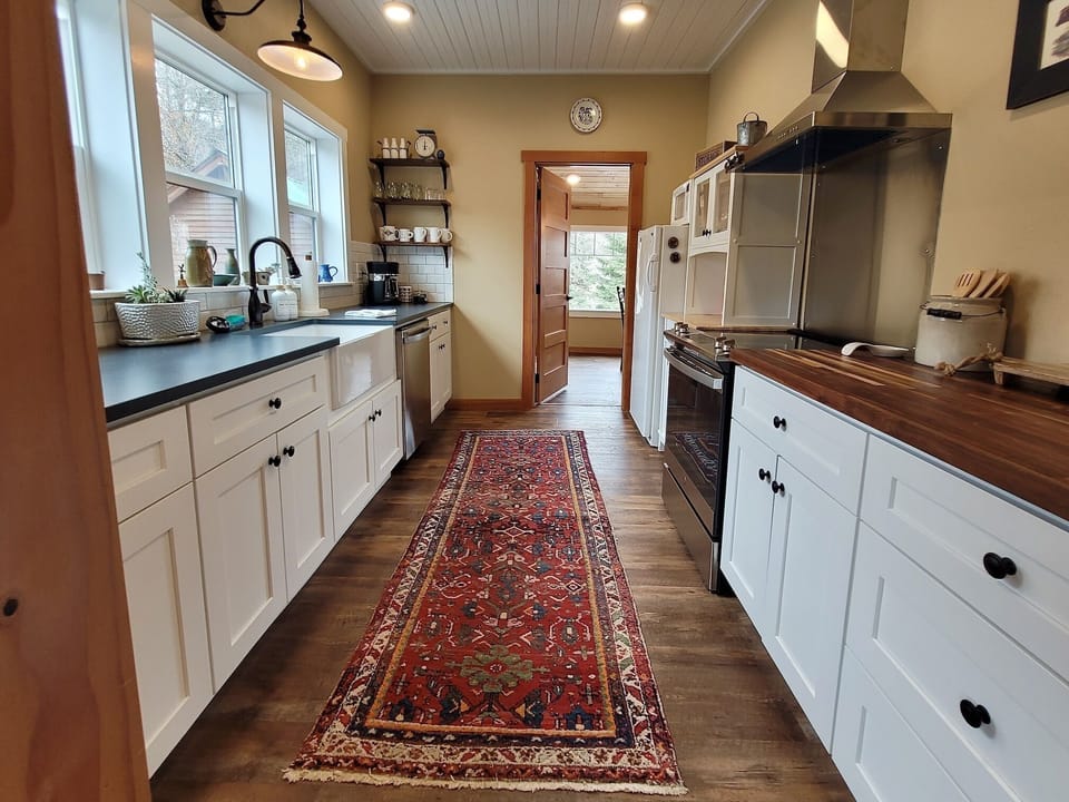 Full kitchen with plenty of natural light and space for preparing meals. 
