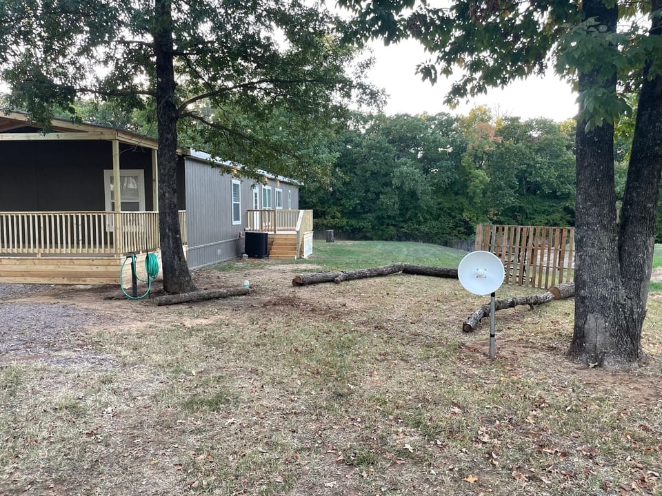 View of the backdoor entrance with deck.  RV parking and set up while you stay. 