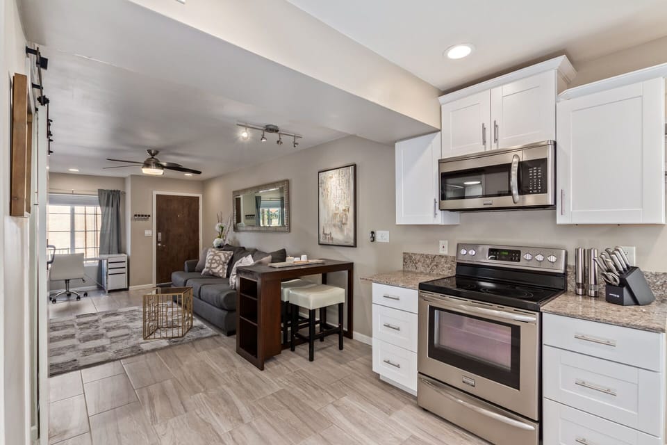 Breakfast bar and kitchen connected to living space