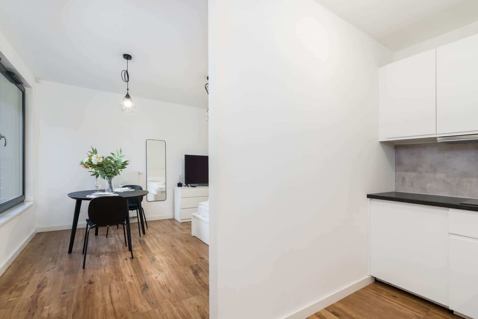 Stylish dining nook perfect for enjoying meals, with large windows bringing in natural light and offering a view of the exterior.

