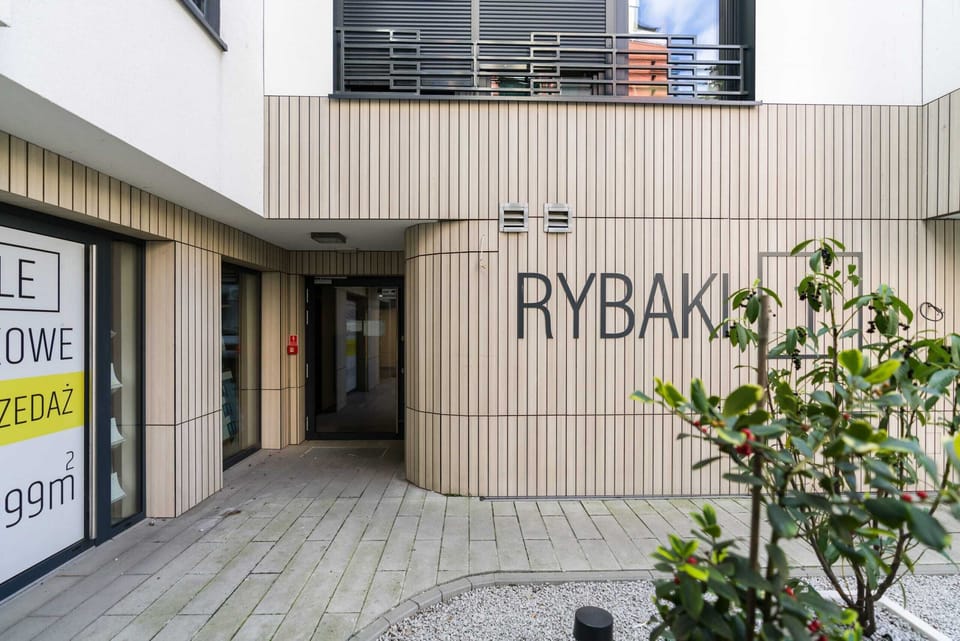 A glimpse of the building's exterior, highlighting its clean lines and contemporary design, creating a welcoming first impression.
