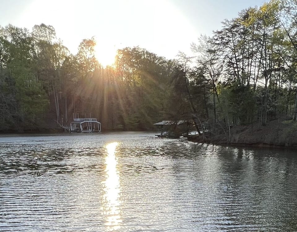 Sit on the upper deck of the dock and watch the sunset over our cove