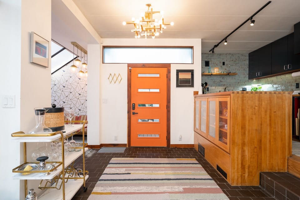 Step into your stylish mid-century modern retreat where warm wood tones and designer lighting create an instantly welcoming atmosphere for your getaway.