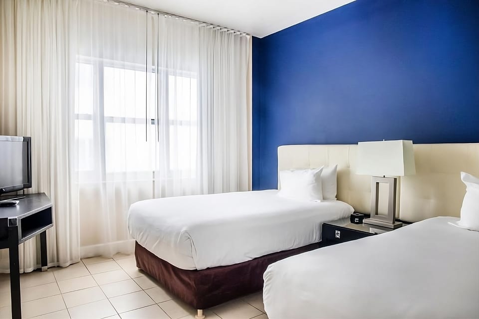 Stretch out in a calming blue room with balcony access.
