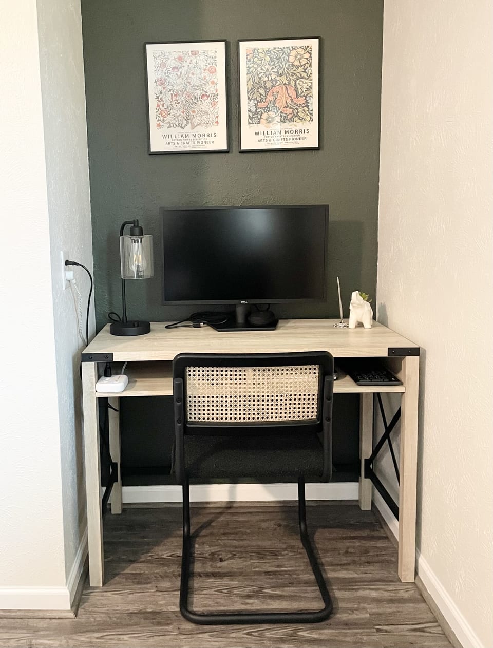 Work nook with charging outlets, a monitor, and a wireless keyboard & mouse.