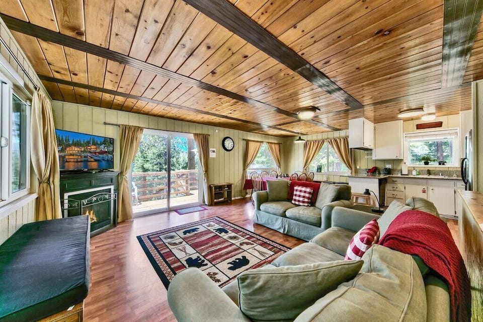 The cozy living room is an ideal space for relaxing after a long day of exploring South Tahoe. This room is equipped with a gas fireplace, comfy couches, and a large flat screen TV.