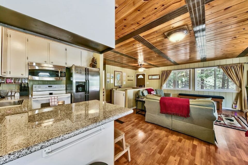 The stunning open-concept kitchen has all the basics for cooking up savory meals. You’ll find modern appliances, spacious granite countertops, a dishwasher, and cookware.