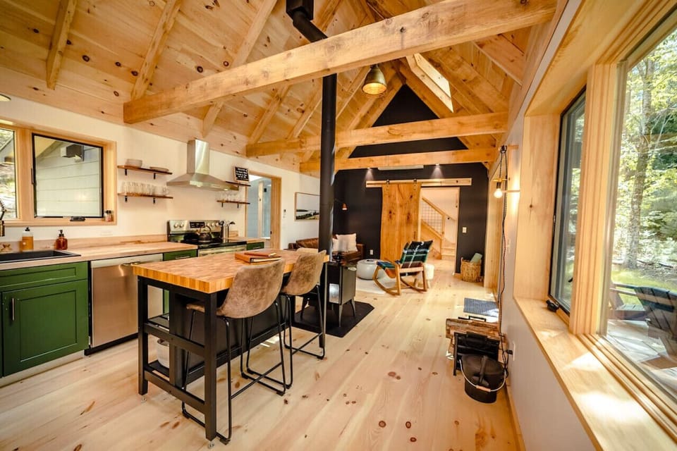 The main living space has a unique cabin feel, centered by the wood stove.