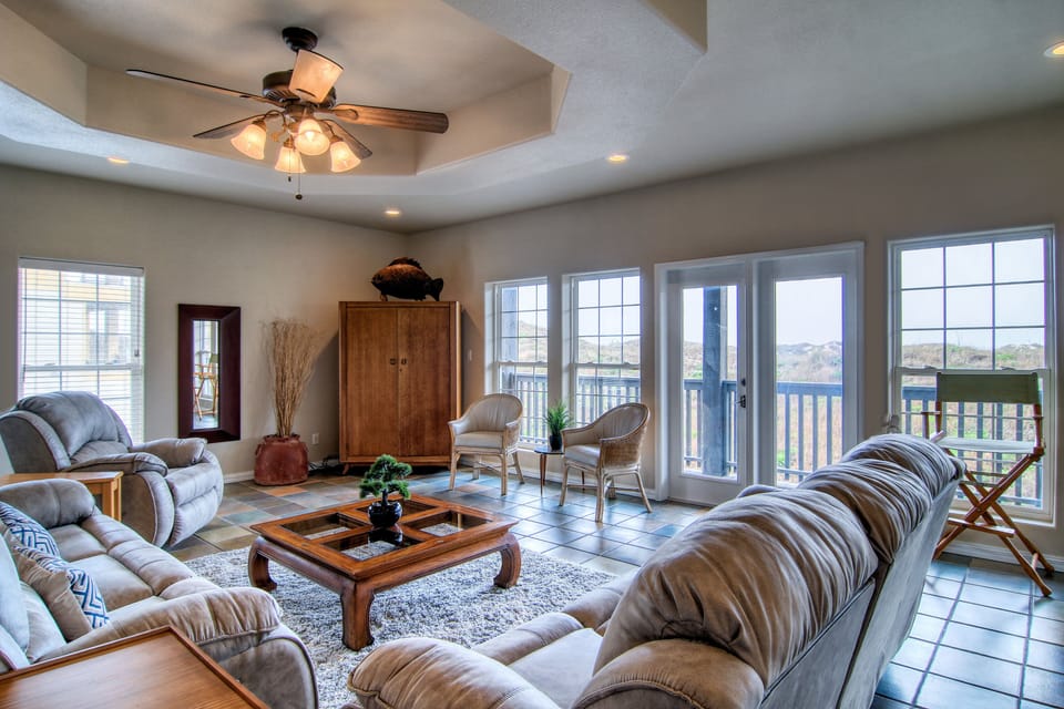 The spacious living room has plenty of seating for everyone.
