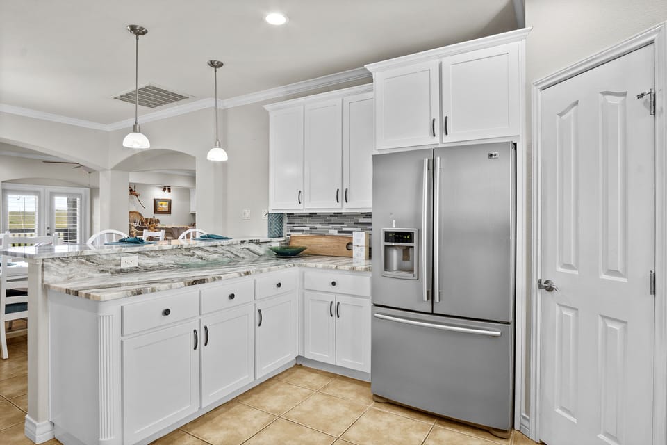 The stainless-steel fixtures and appliances add both beauty and function to the kitchen.