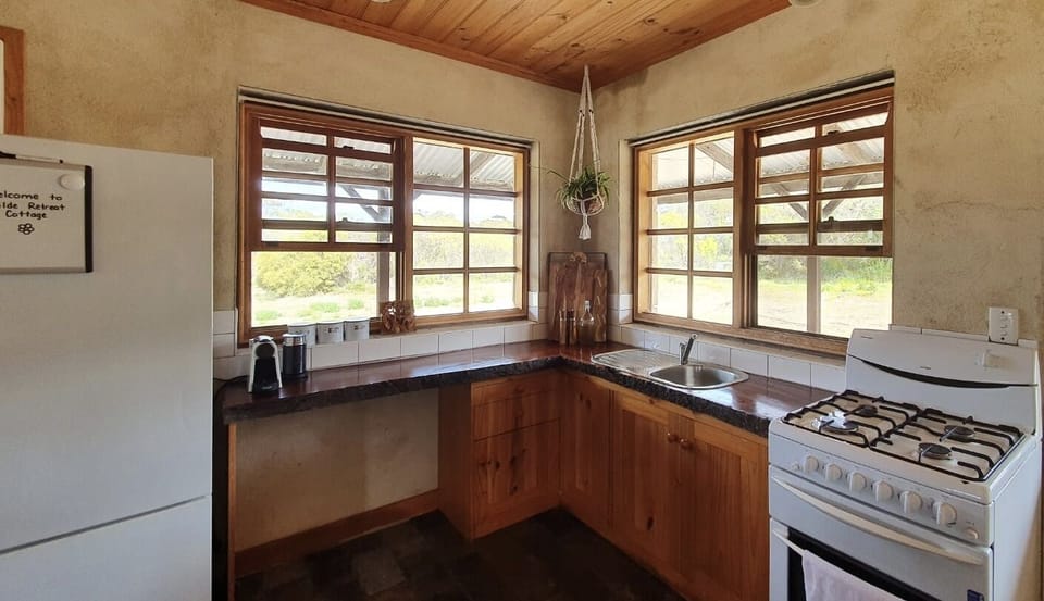Kitchen: fridge, gas oven, Nespresso machine, cooking utensils and glassware 